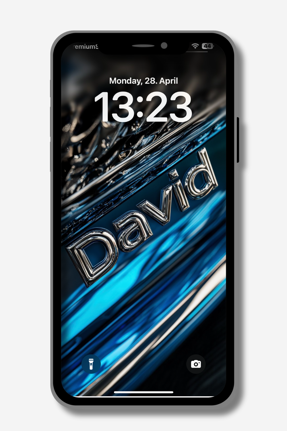 A smartphone displays a lock screen with the name "David" in a bold, metallic silver font angled across a dynamic background of swirling blues, blacks, and silvers, suggesting movement. The time reads 13:23, and the date is Monday, April 28. Flashlight and camera icons are at the bottom.