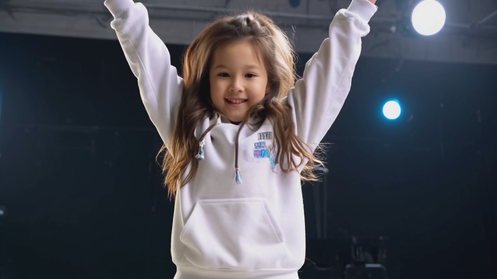 Mixed media: A girl dances with an animated monkey in a dance studio